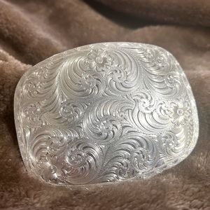 Oval Women’s western style engraved silver belt buckle by Montana Silversmiths.